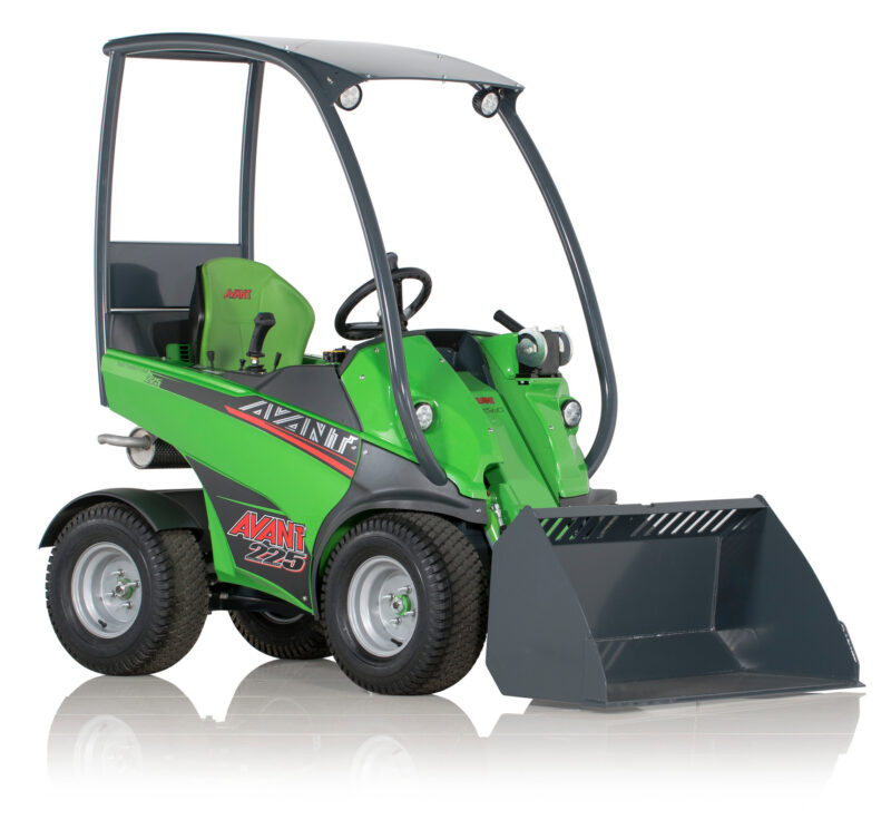 Green Avant 225 compact loader with a large front snow blade attachment and curved rollover frame.