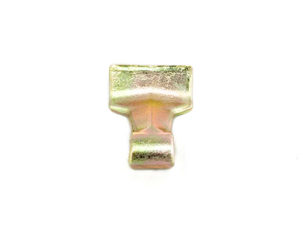 Close-up of an iridescent metal buckle or clasp attached to a light fabric strap.