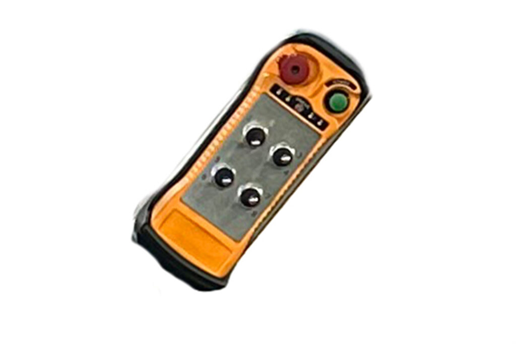 Close-up of a yellow handheld multimeter showing red and green input jacks at the top edge of the device